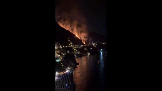 Massive wildfire spreads across hillside overlooking Positano, Italy