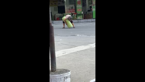 Elderly woman lifts giant zucchini in Fujian Province, China