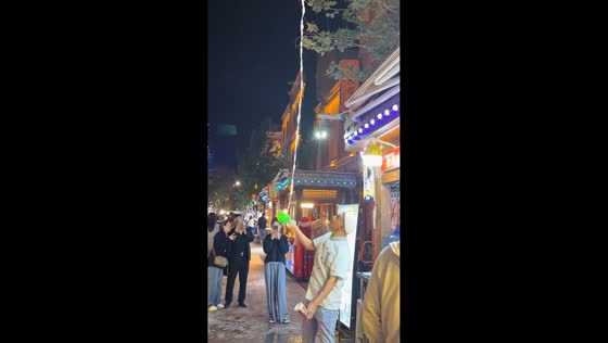 Street vendor tosses and catches shaved ice with precision in Kashgar, Xinjiang, China