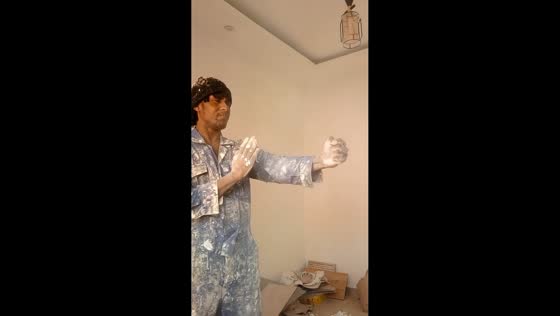 Man performs martial arts movements while covered in paint in Kisii, Kenya