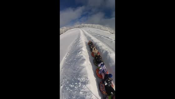 Friends ride inflatable ring through snowy slide in Jilin, China