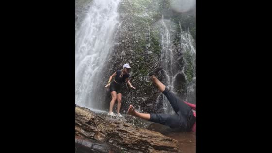 Person falls near Cataratas El Tigre waterfalls in Costa Rica