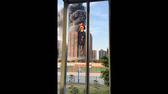 Massive high-rise apartment fire sends thick black smoke into the sky in Henan, China