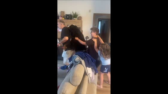 Dog takes part in family train dance inside home in Arona, Italy