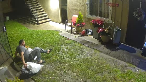 Man slips while taking out the trash in San Juan Capistrano, California, USA