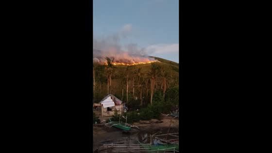 Rapidly spreading grass fire in Palumbanes Islands, Catanduanes, Philippines