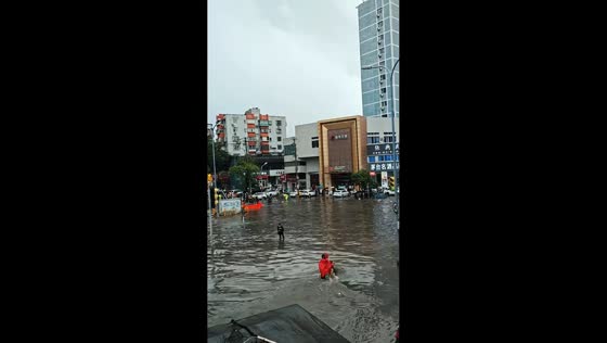 Murky floodwater submerges street and vehicles after rainstorm in Shandong, China