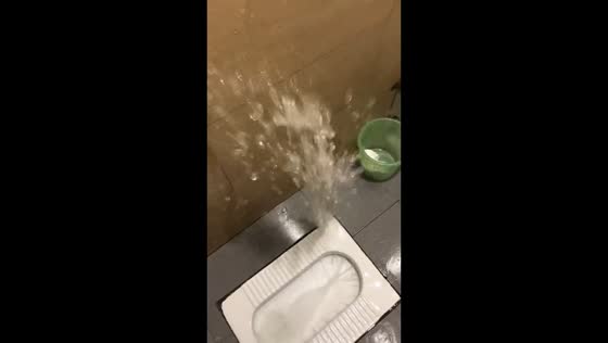 Squat toilet with hole malfunctions and sprays upward in Heilongjiang, China