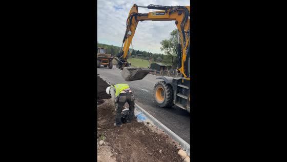 Roadside repair oops: companion's chuckle as pants slip!