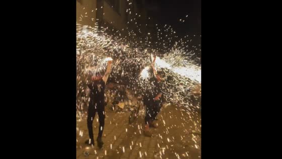 People swing burning steel wool, creating sparks in Gaza