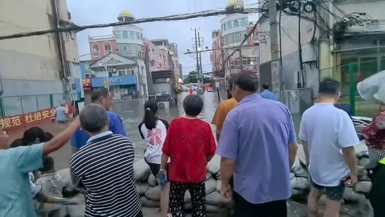 Sandbag barrier deployed as flooding inundates street in Shanghai, China