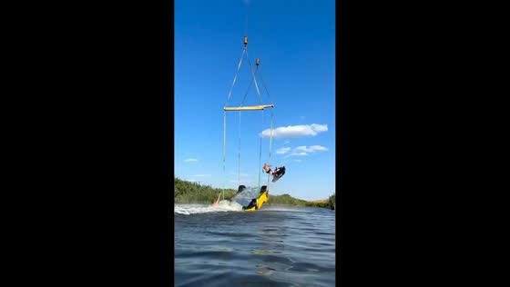 Jet ski rider launches off elevated ramp beneath suspended Ferrari in Rostov-on-Don, Russia