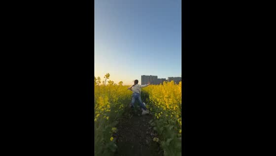 Woman trips while running with dog at flower field in Shanghai, China