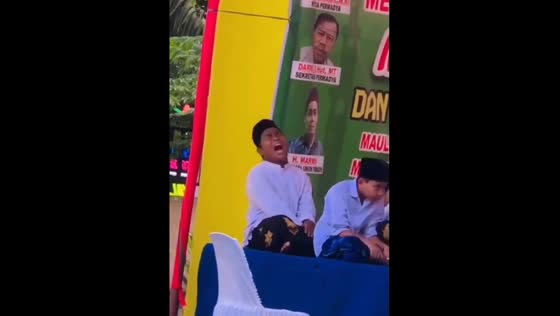 One child accidentally hits another child's back while performing at a cultural celebration