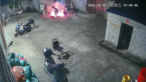 Sudden fire flare startles men during outdoor barbecue in Guangxi, China