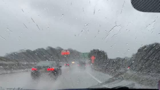 Driver braves windswept rain during commute in Sunol, California, USA