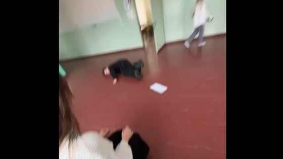 Person spins holding paper and falls after placing it down in Severodvinsk