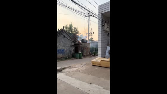 Electrical transformer sparks and smokes after falling on shed in Henan, China
