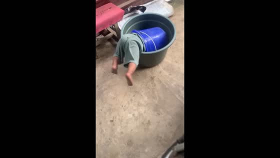 Toddler takes a tumble in double bucket mishap