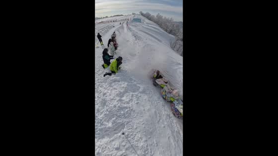 Group enjoys thrilling snow tubing down steep slope in Sichuan, China