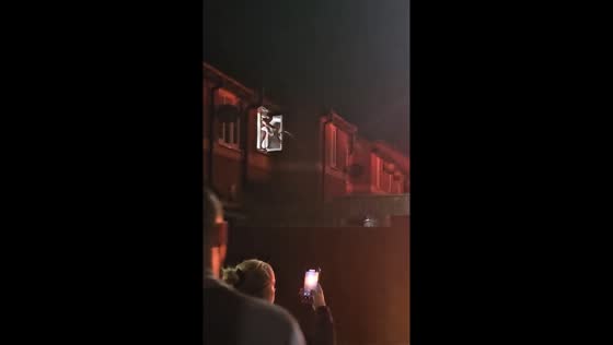 Person sprays water to protect home from nearby car fire amid Hartlepool riots