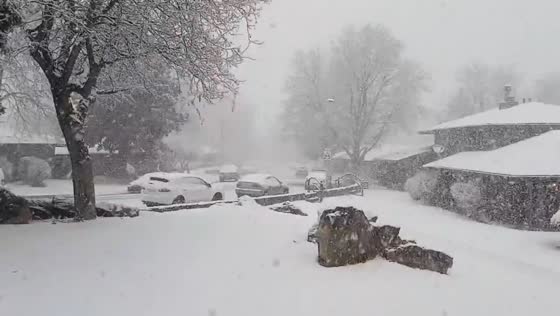Heavy snowfall blankets roads and cars in Aurora, Colorado, USA