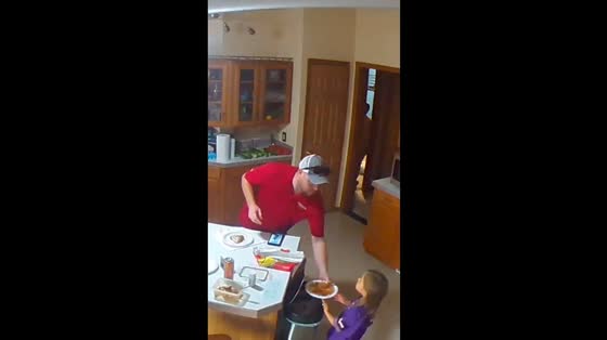 Little girl tries to hide spaghetti in Milltown, Wisconsin, USA