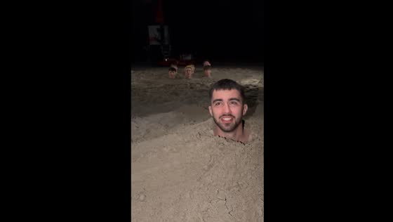 Group bury themselves in sand and sing 'SpongeBob' in Milano Marittima, Italy