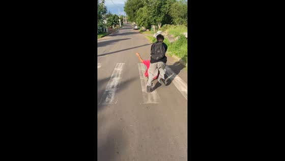 Two men fall off skateboard during downhill ride in São Jerônimo, Brazil