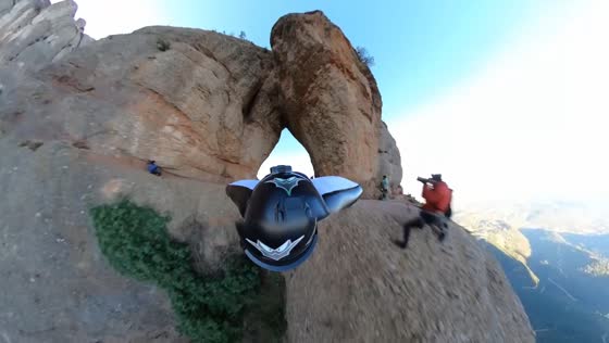 Wingsuit flyer glides through mountain hole in Barcelona, Spain